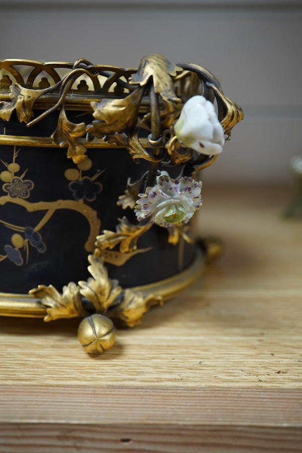 A French ormolu and lacquered jardiniere with porcelain mounted handles, stamped 'Bointaburet A Paris', together with a ‘pear’ candle display. Jardiniere width 23cm. Condition - one handle damaged, interior rubbed